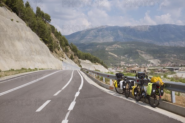 Bicycles leaning on freeway guardrail