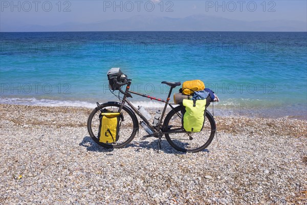 Bicycle parked on rocky beach