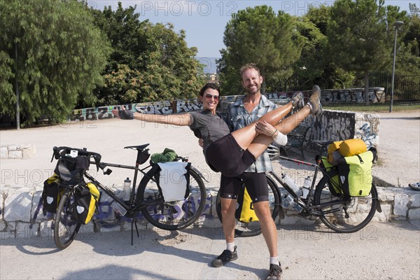 Man carrying girlfriend on bicycle journey