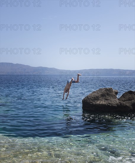 Caucasian man diving into ocean