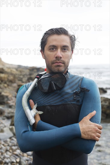 Hispanic diver wearing snorkel mask