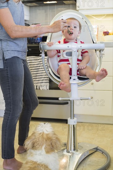 Mixed race mother feeding baby outdoors