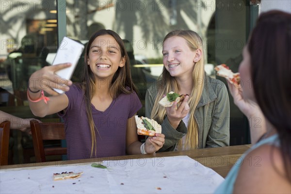 Girls taking selfie in cafe