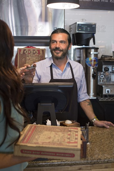 Customer purchasing pizza in cafe