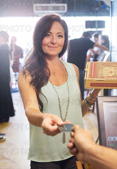 Customer purchasing pizza in cafe