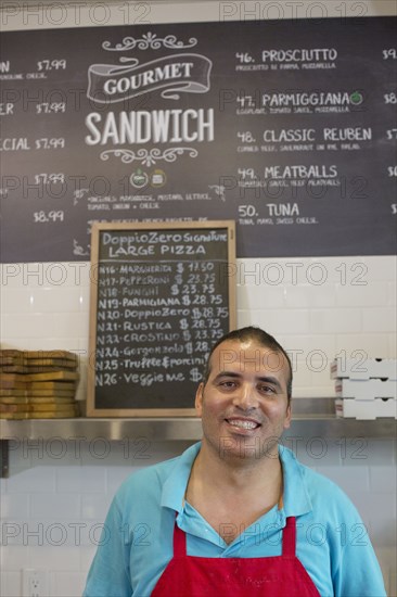 Server smiling in cafe