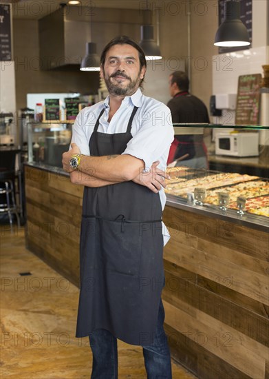 Server smiling in cafe