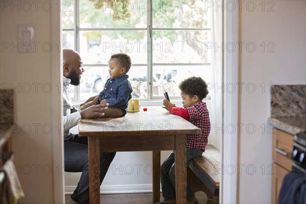 Father and children sitting at table