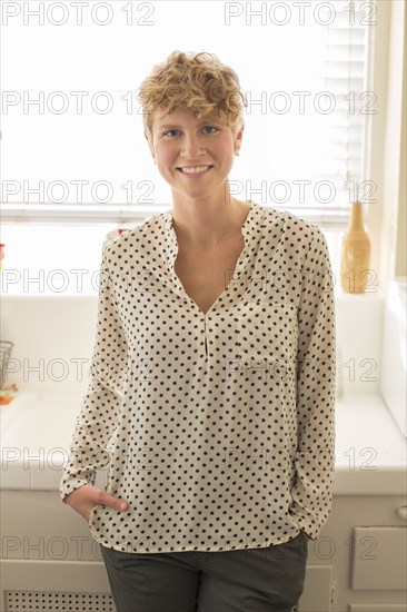 Caucasian woman smiling in kitchen