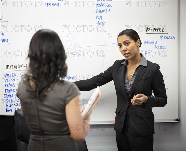 Businesswomen talking in office