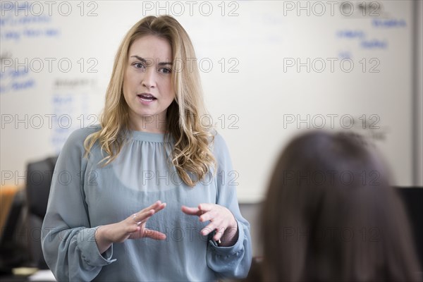 Caucasian businesswomen talking in office