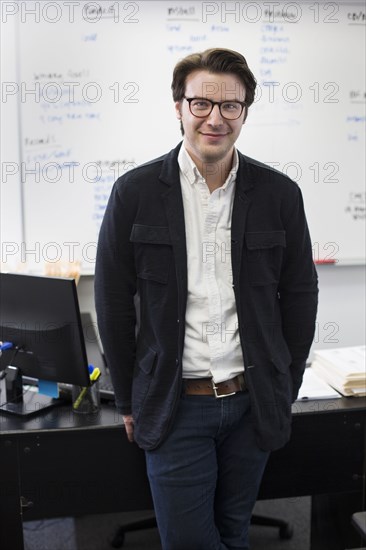 Caucasian businessman smiling in office