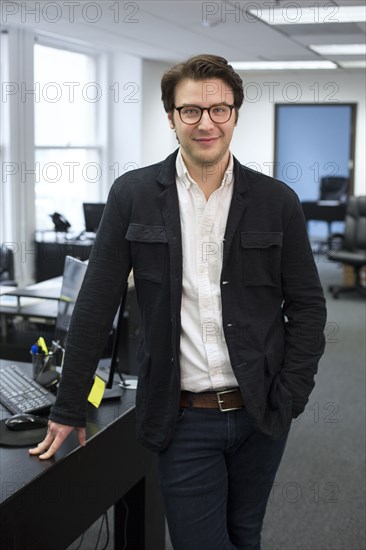 Caucasian businessman smiling in office