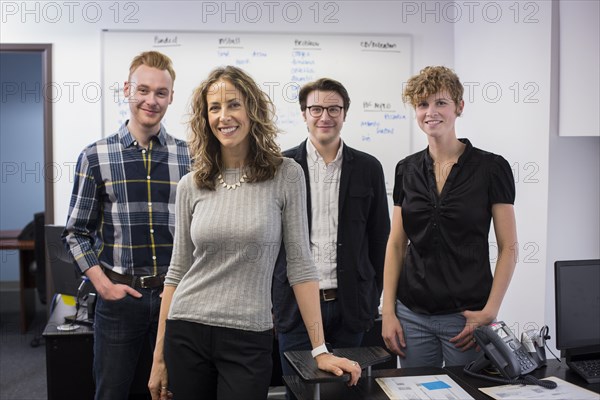 Caucasian business people smiling in office