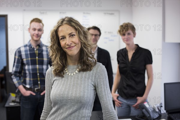 Caucasian businesswoman smiling in office