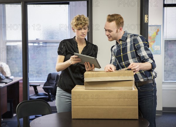Caucasian business people using digital tablet in office