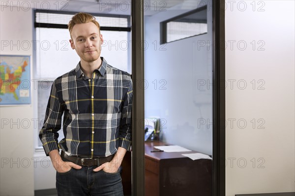 Caucasian businessman smiling in office