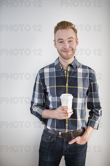 Caucasian businessman drinking coffee