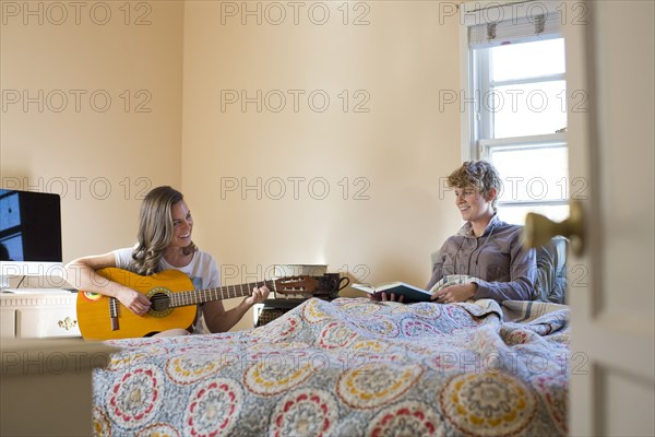 Caucasian lesbian couple relaxing in bedroom