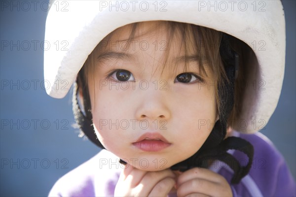 Serious mixed race girl in helmet