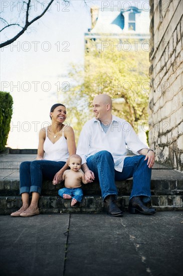 Family sitting on urban park steps