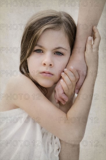 Close up of anxious girl holding hand of mother