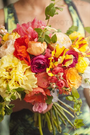 Close up of woman holding bouquet of flowers