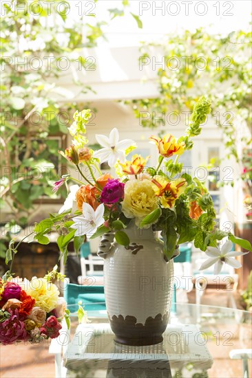 Bouquet of flowers in vase on backyard patio