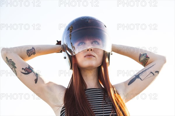 Caucasian woman wearing motorcycle helmet