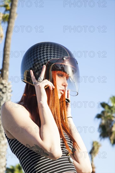 Caucasian woman wearing motorcycle helmet