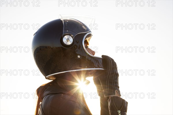 Caucasian woman wearing motorcycle helmet