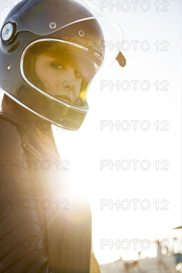 Caucasian woman wearing motorcycle helmet