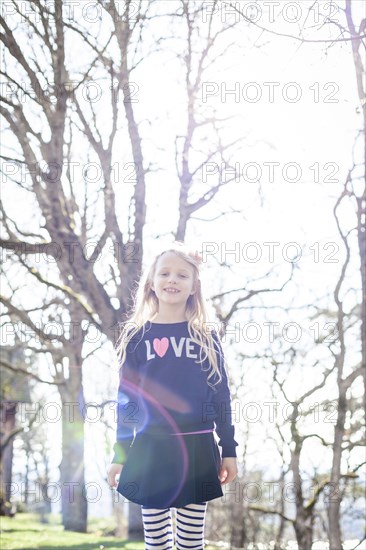 Smiling girl walking in park