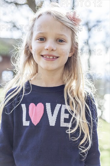 Smiling girl wearing love sweater