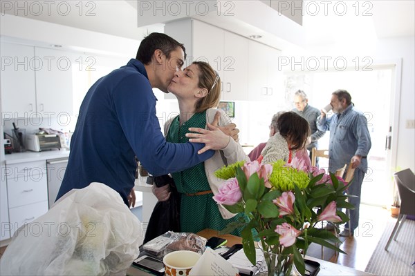 Couple kissing in kitchen