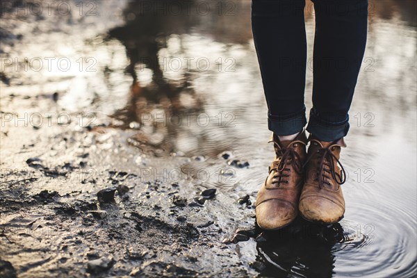 Close up of woman standing in puddle
