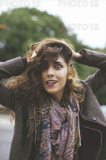 Middle Eastern woman tossing her hair outdoors