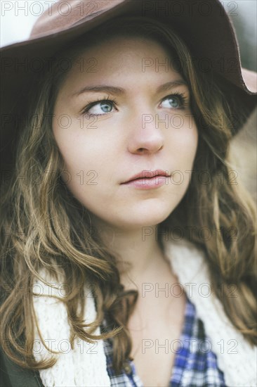 Pensive Caucasian woman wearing sun hat