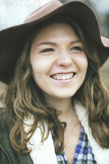 Smiling Caucasian woman wearing sun hat