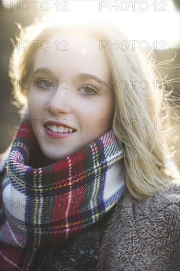 Smiling Caucasian woman wearing plaid scarf