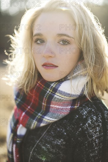 Serious Caucasian woman wearing plaid scarf