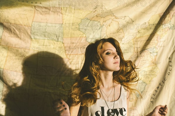 Caucasian woman standing in front of fabric map