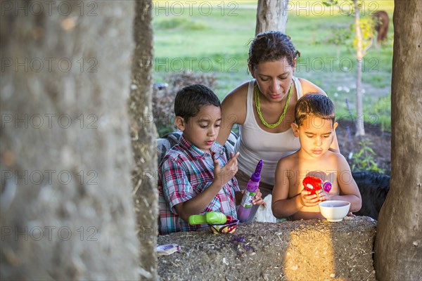 Mother and sons playing in backyard