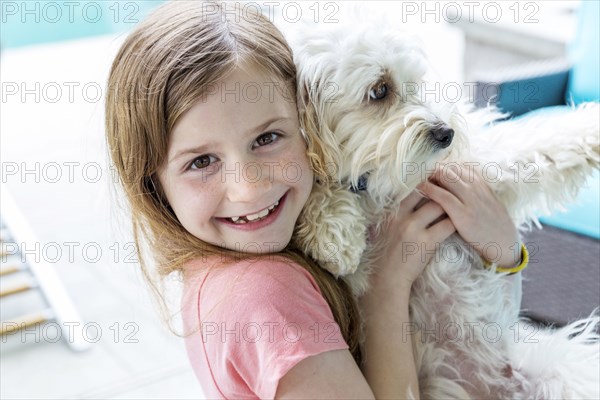 Close up of Caucasian girl hugging puppy