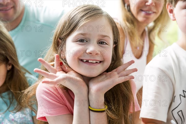 Close up of Caucasian girl smiling with family