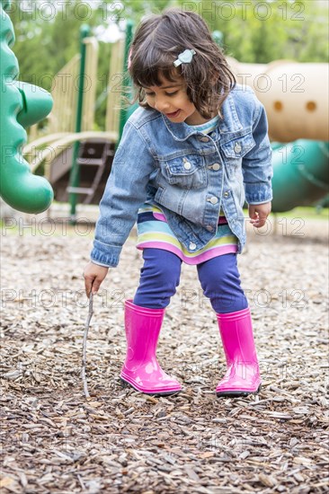 Girl playing with stick at playground