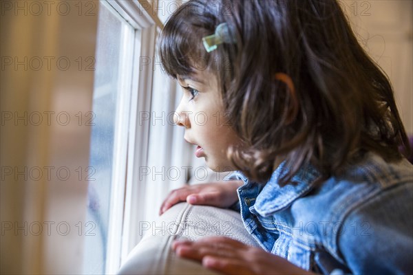 Close up of girl looking out window