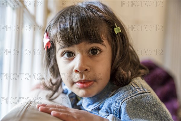 Close up of girl sitting on sofa