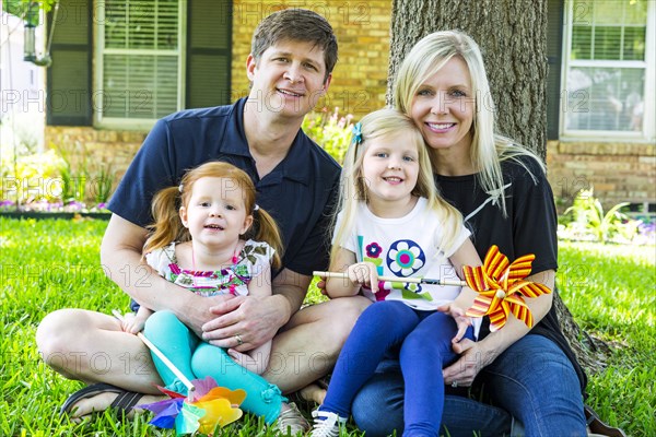 Caucasian family smiling in backyard