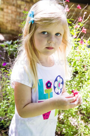 Caucasian girl playing in backyard